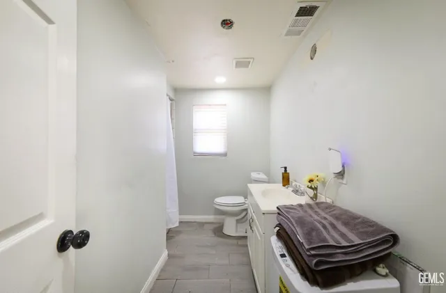 a bathroom with a sink a toilet and a mirror
