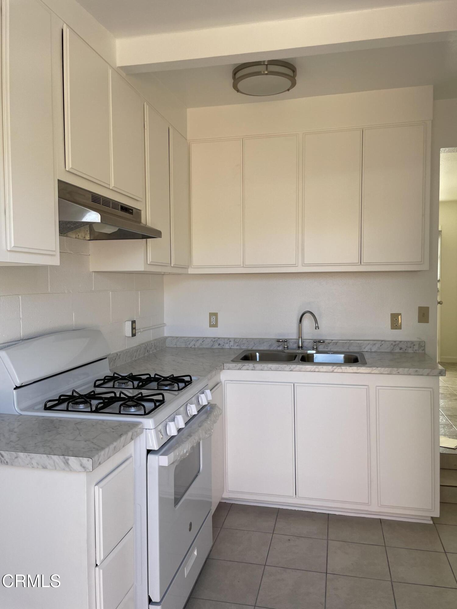 524 Anacapa Drive Camarillo, CA 93010 - Photo 1 of 9 a kitchen with granite countertop a sink a stove and cabinets