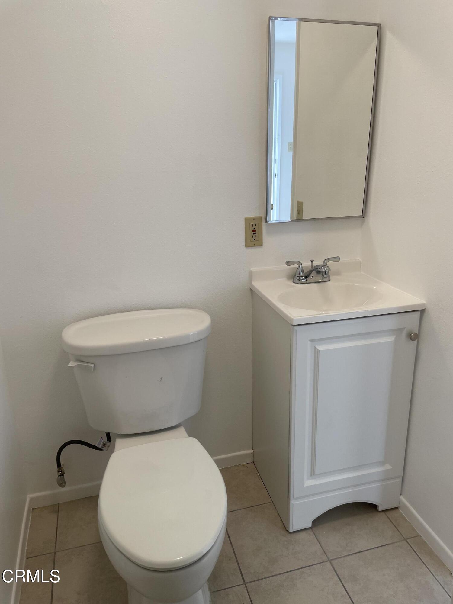 524 Anacapa Drive Camarillo, CA 93010 - Photo 6 of 9 a bathroom with a toilet a sink and mirror