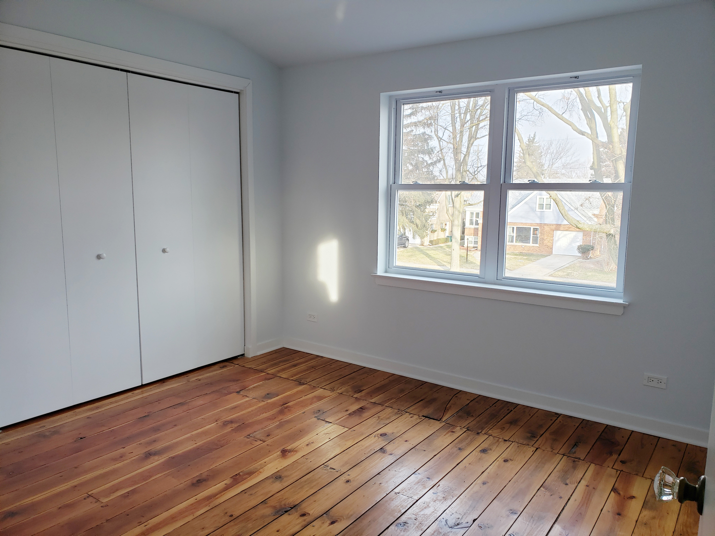 57 Northgate Road Riverside, IL 60546 - Photo 19 of 28 a view of an empty room with wooden floor and a window