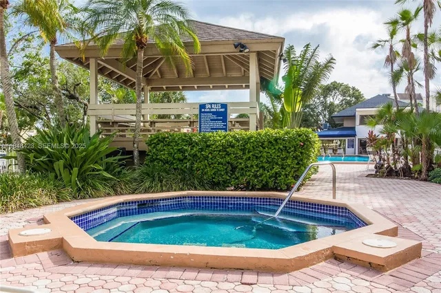 a view of a small pool in the backyard of a house
