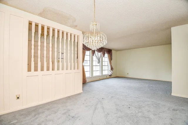 a view of a room with window and chandelier