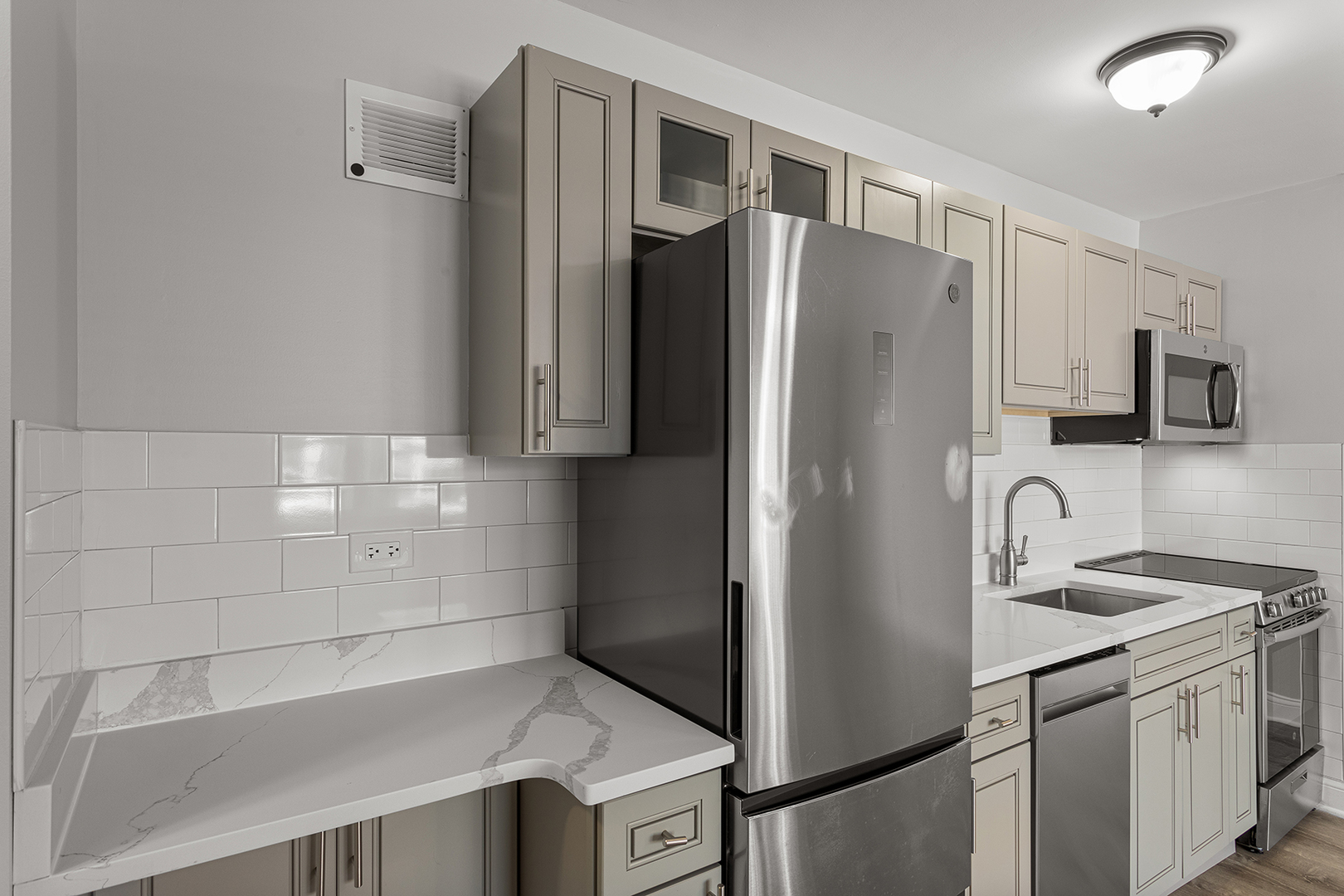 7710 North Sheridan Road, Unit 304 Chicago, IL 60626 - Photo 5 of 13 a kitchen with stainless steel appliances granite countertop a refrigerator and a sink