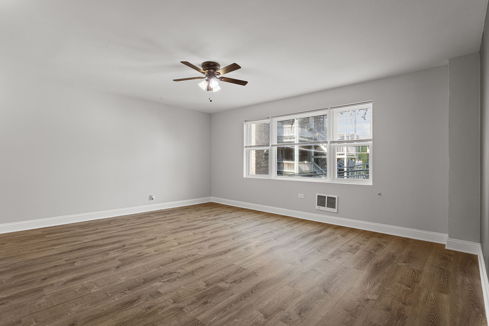7710 North Sheridan Road, Unit 304 Chicago, IL 60626 - Photo 6 of 13 a view of an empty room with a window and wooden floor
