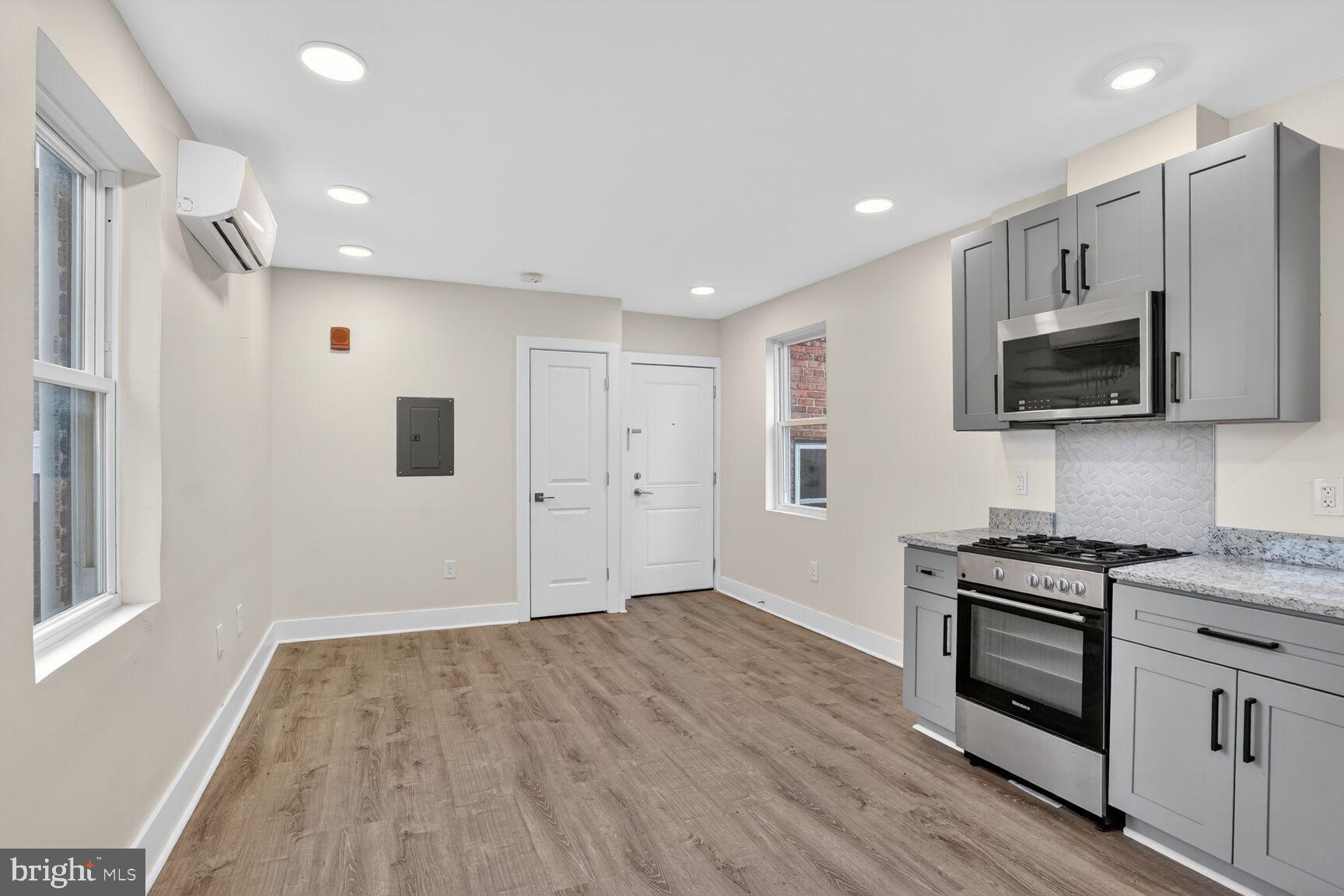 1821 T Street Northwest Washington, DC 20009 - Photo 13 of 40 a kitchen with stainless steel appliances a white stove top oven a sink and a microwave