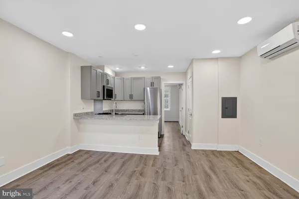 a view of a kitchen with a sink and a refrigerator