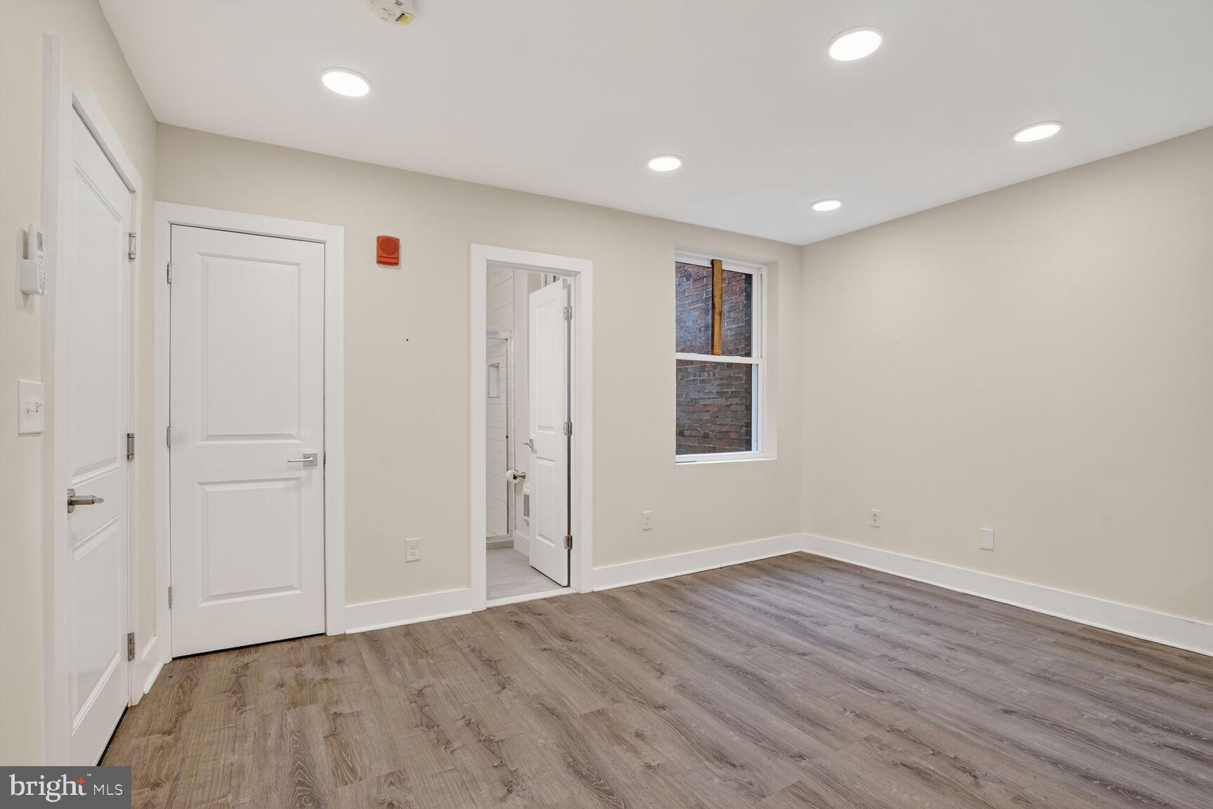 1821 T Street Northwest Washington, DC 20009 - Photo 27 of 40 a view of an empty room with wooden floor
