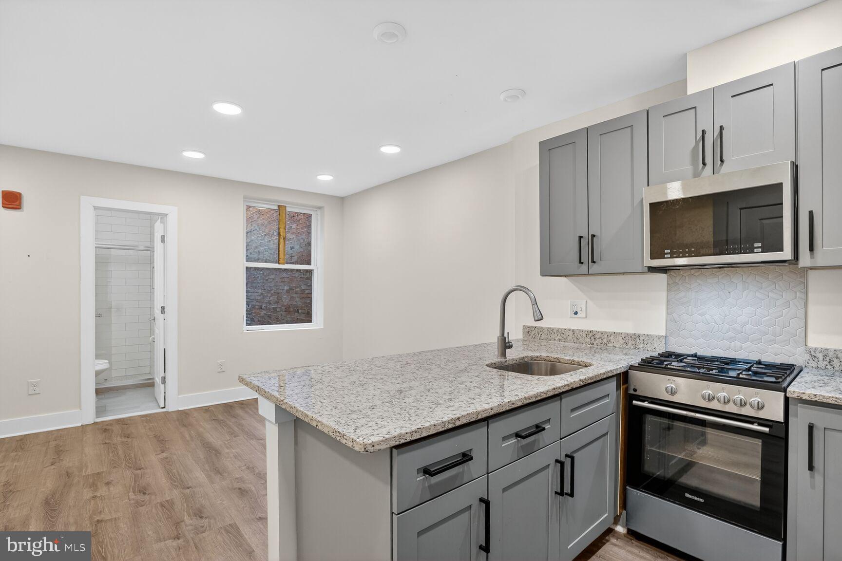 1821 T Street Northwest Washington, DC 20009 - Photo 31 of 40 a kitchen that has a sink and a stove top oven