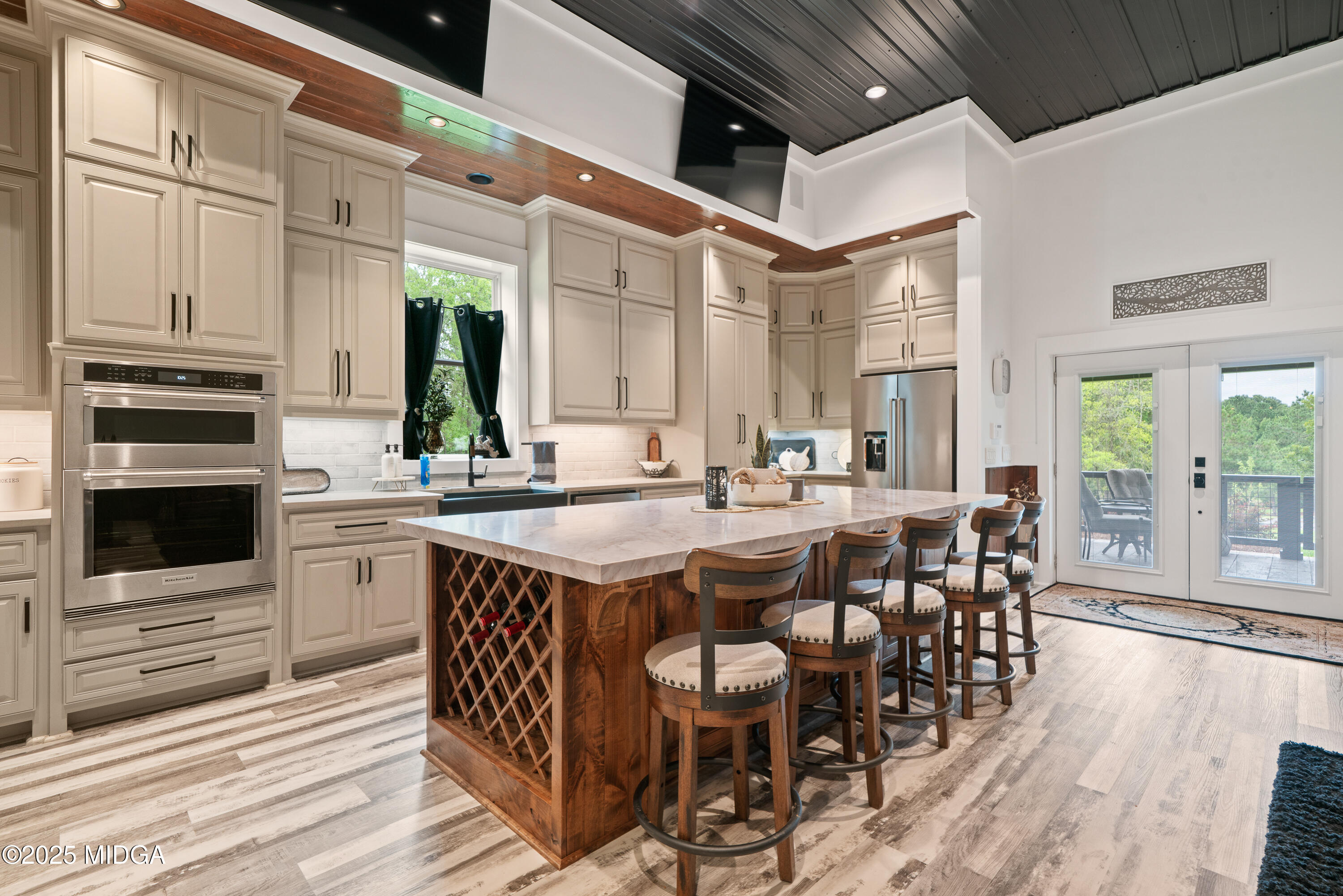 1971 Highway 49 Gray, GA 31032 - Photo 28 of 98 a open kitchen with stainless steel appliances granite countertop a stove a sink dishwasher and a dining table with wooden floor