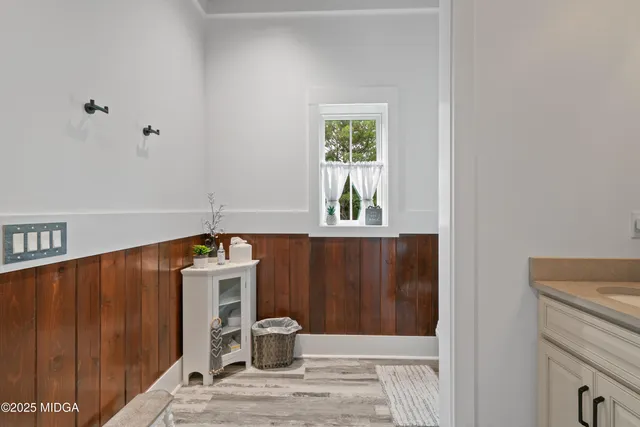 a view of green field with trees in the background