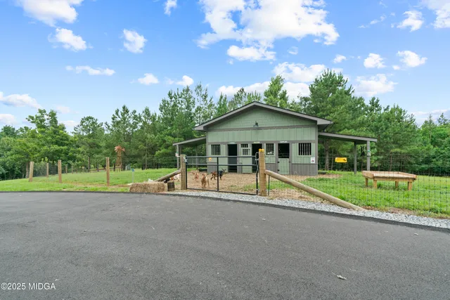 a view of a backyard with lawn chairs and a fire pit