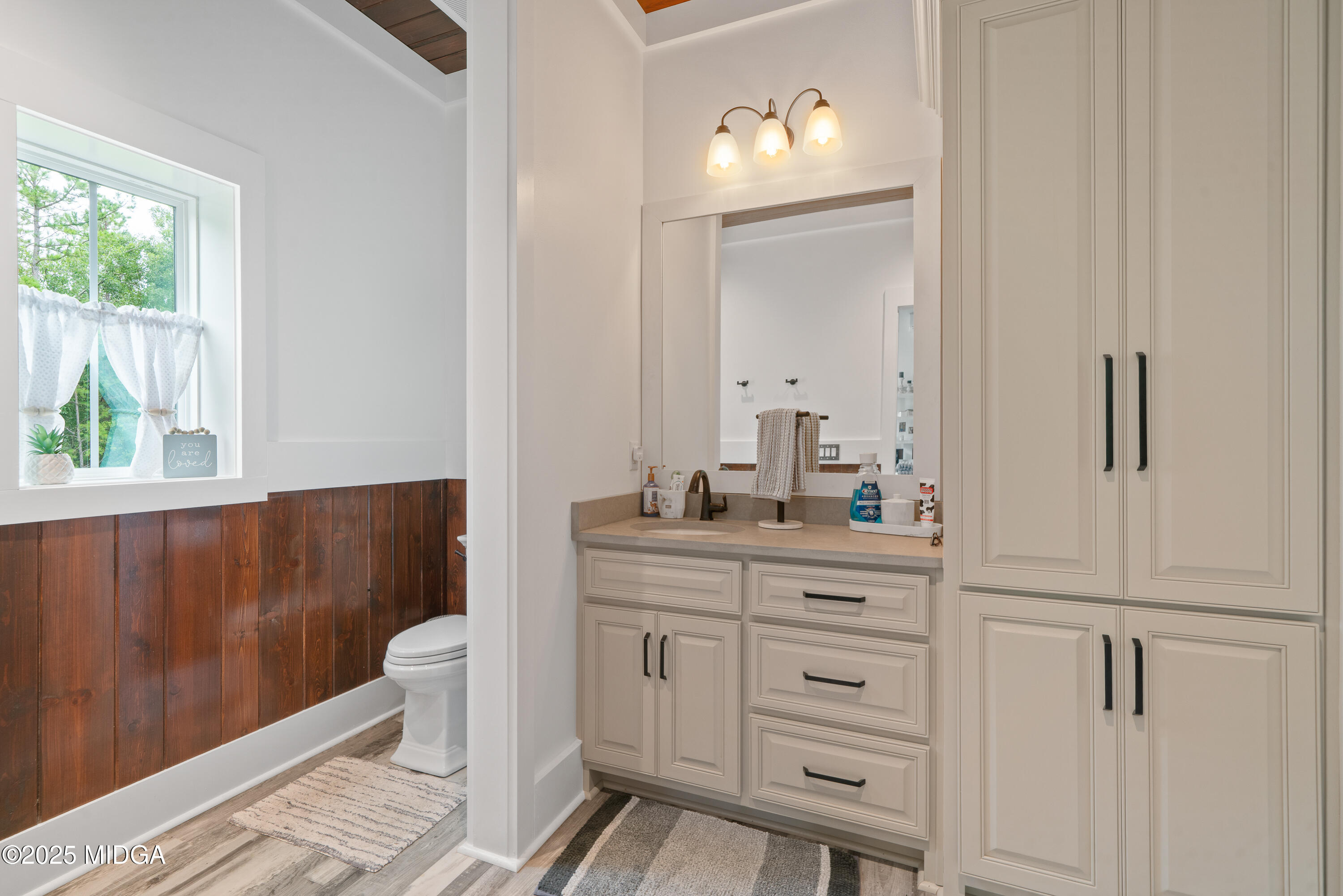 1971 Highway 49 Gray, GA 31032 - Photo 41 of 98 a bathroom with a toilet a sink a mirror a window and vanity