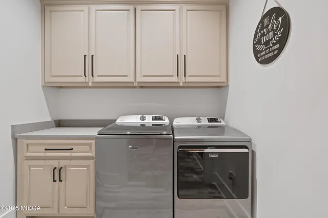 a view of a field with a lush green forest