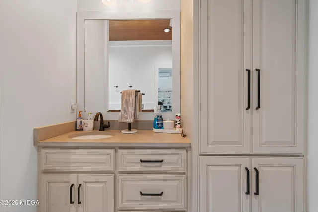 an aerial view of residential houses with outdoor space and trees