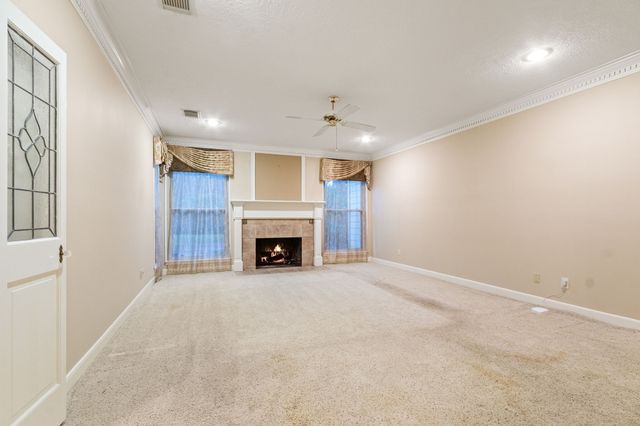 a view of an empty room with a fireplace