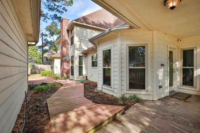a view of a brick house with a large windows