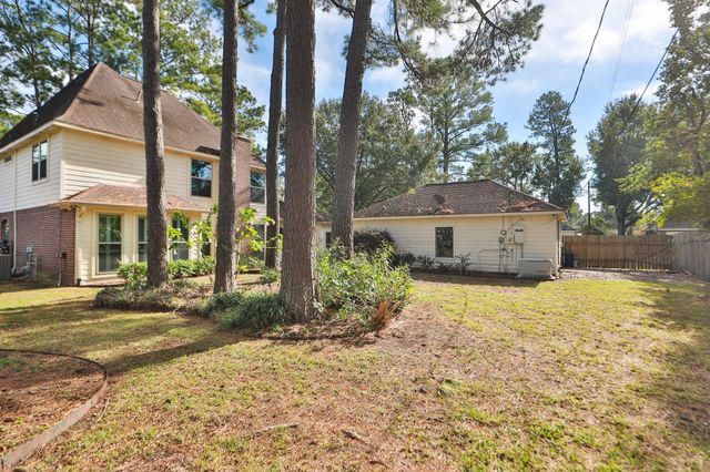 a front view of a house with a yard and trees