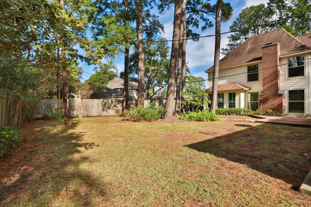 a street sign on a sidewalk next to a road