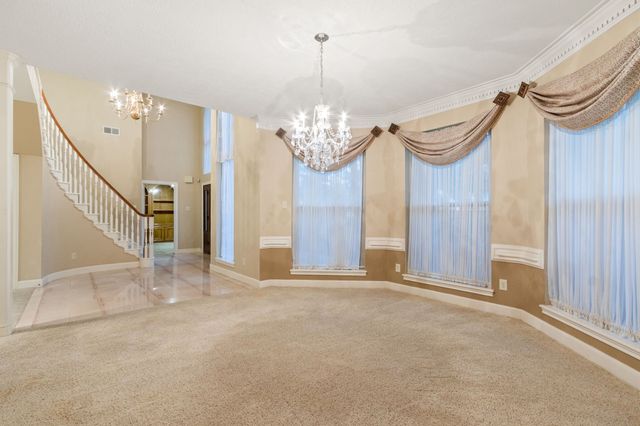 a view of a chandelier in big room and painted walls