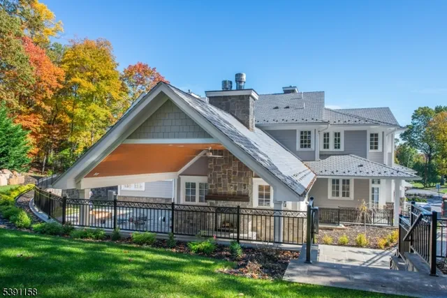 a front view of a house with a yard and trees