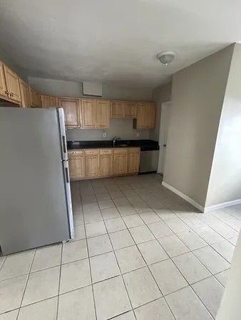 a kitchen with cabinets and window