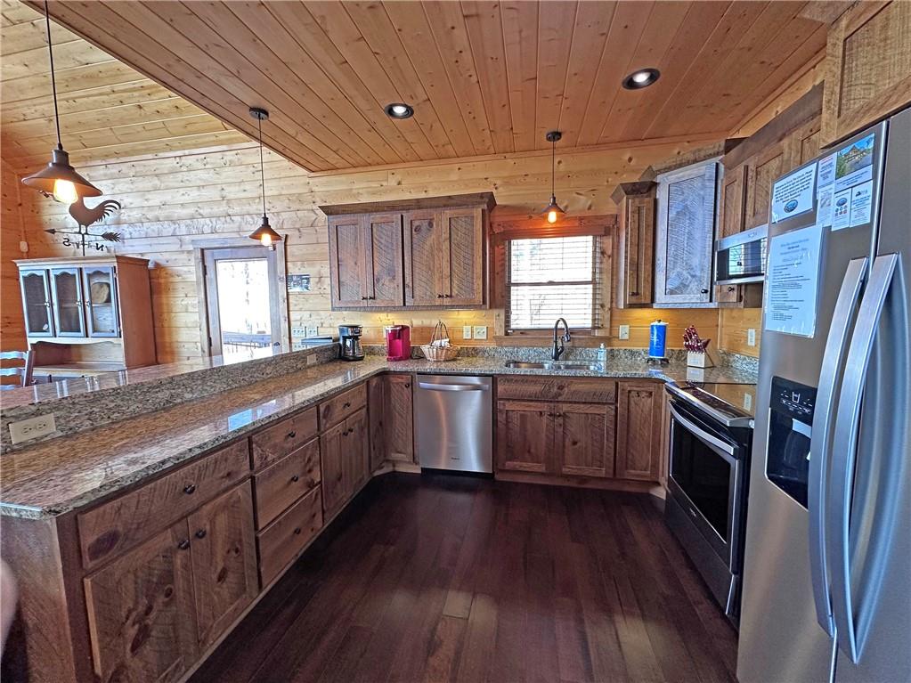 2175 Andes Ridge Talking Rock, GA 30175 - Photo 26 of 51 a kitchen with stainless steel appliances granite countertop wooden floors a stove a sink and a window