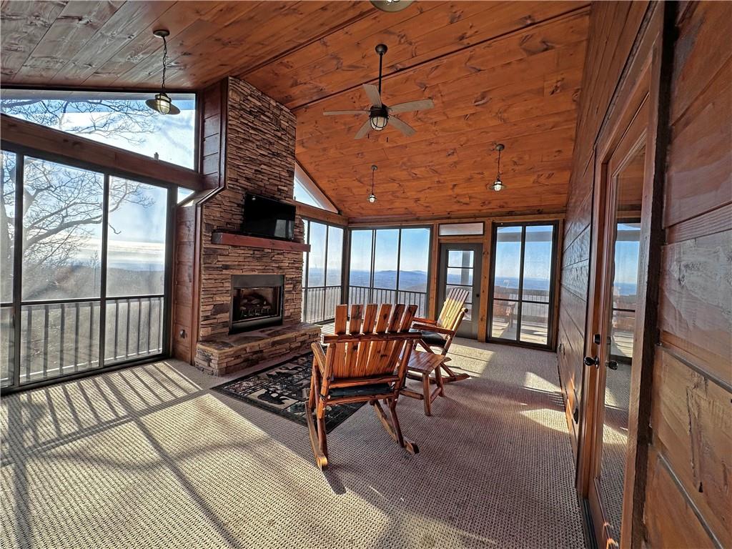 2175 Andes Ridge Talking Rock, GA 30175 - Photo 30 of 51 a living room with furniture a fireplace and a floor to ceiling window