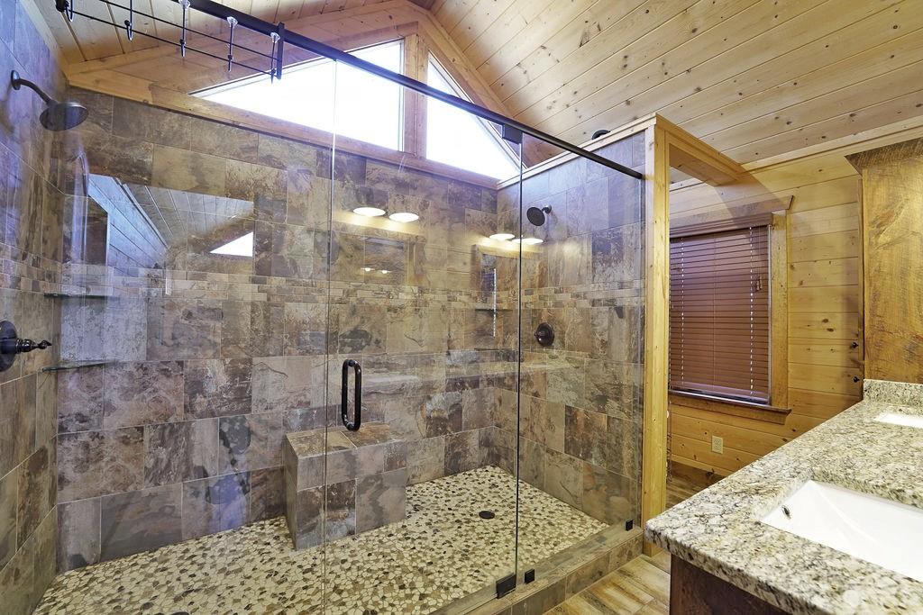 2175 Andes Ridge Talking Rock, GA 30175 - Photo 35 of 51 a bathroom with a granite countertop shower a sink and a shower