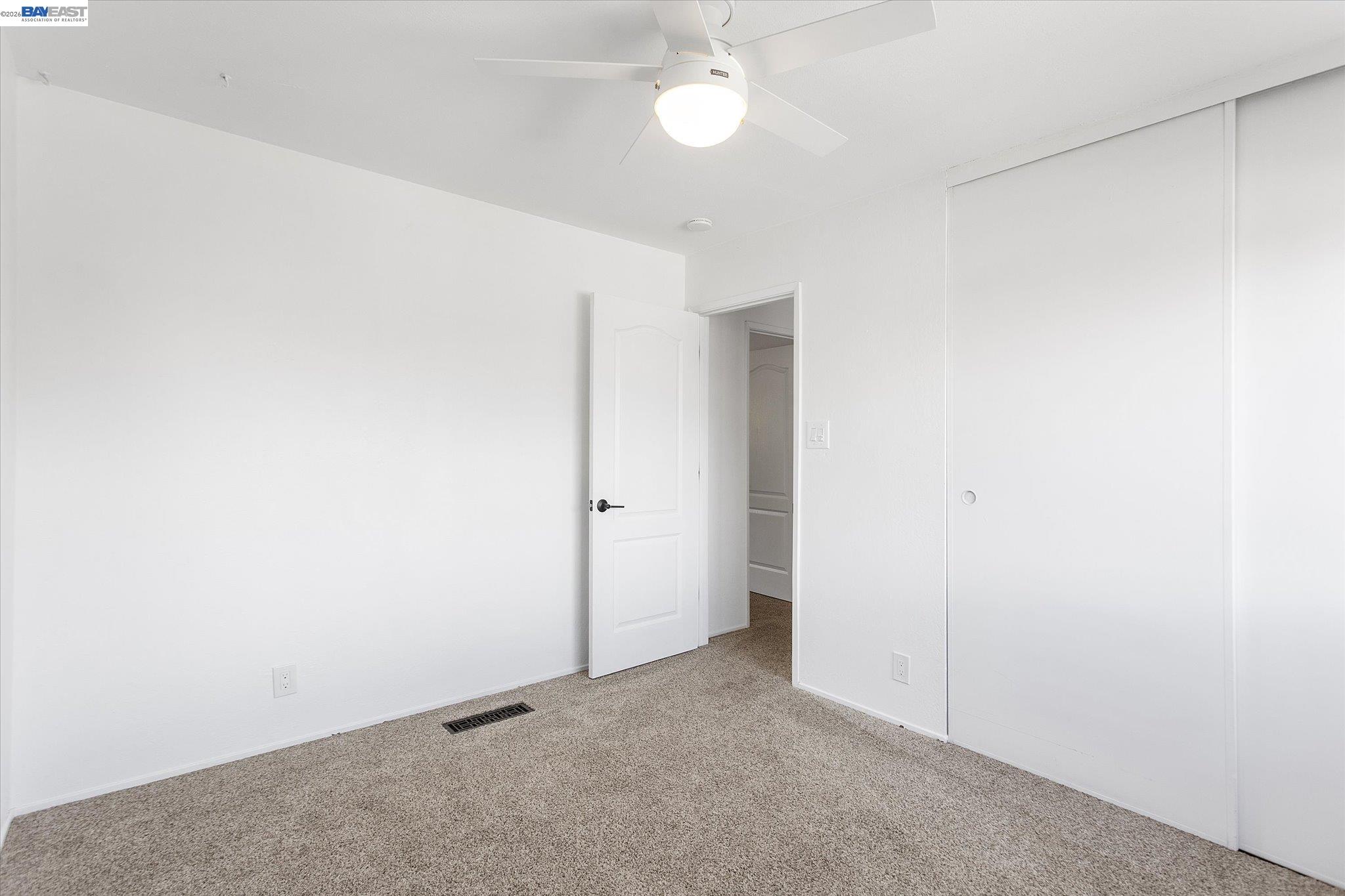 16683 Kildare Road Castro Valley, CA 94546 - Photo 39 of 77 an empty room with a ceiling fan and a fan