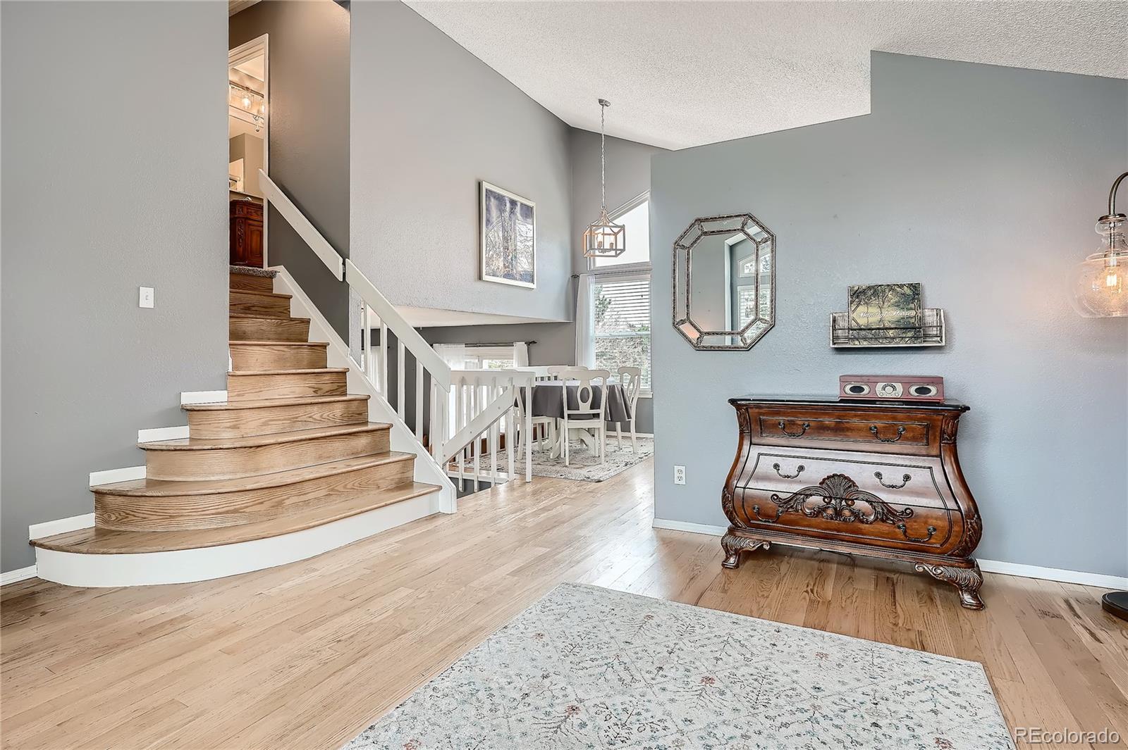 8994 Bermuda Run Circle Highlands Ranch, CO 80130 - Photo 13 of 30 a living room with stairs and a wooden floor