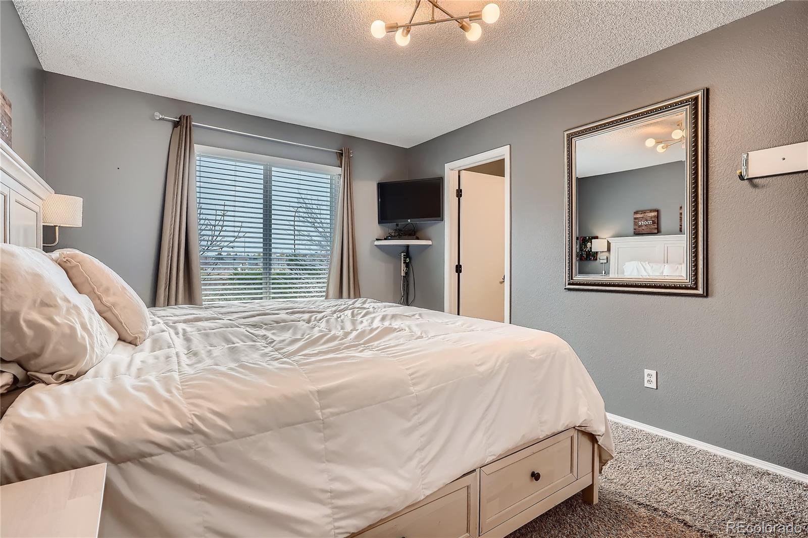 8994 Bermuda Run Circle Highlands Ranch, CO 80130 - Photo 15 of 30 a bedroom with a bed and a window