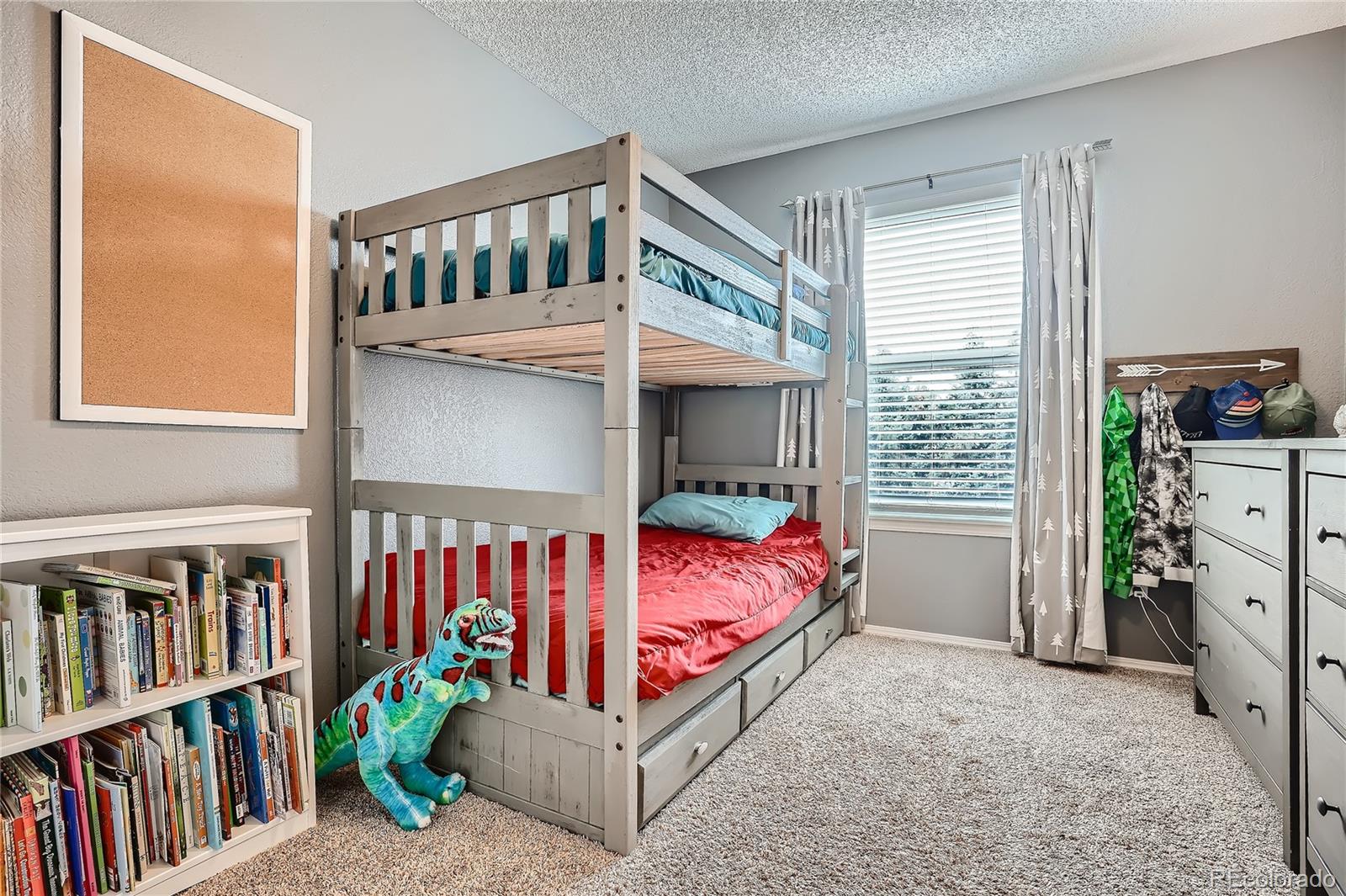 8994 Bermuda Run Circle Highlands Ranch, CO 80130 - Photo 20 of 30 a bedroom with a bed a book shelf and a couch