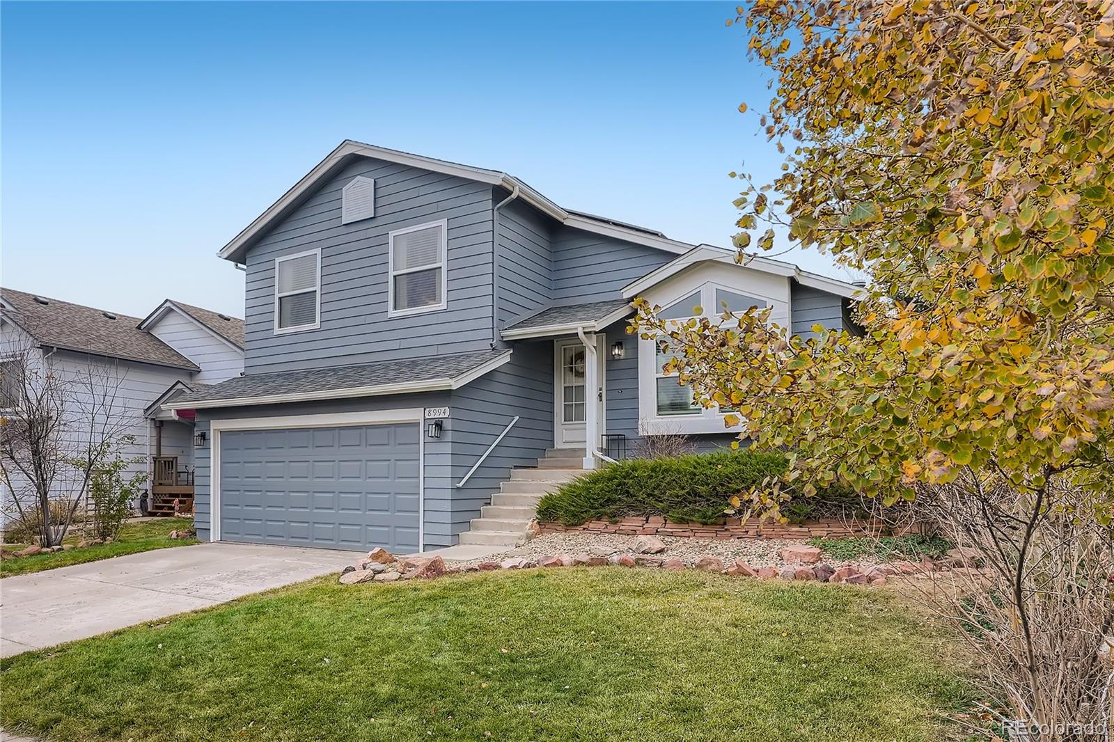 8994 Bermuda Run Circle Highlands Ranch, CO 80130 - Photo 2 of 30 a front view of a house with a yard and garage