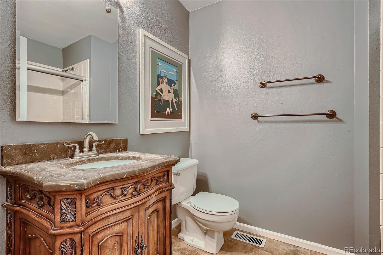 8994 Bermuda Run Circle Highlands Ranch, CO 80130 - Photo 22 of 30 a bathroom with a granite countertop sink and a toilet