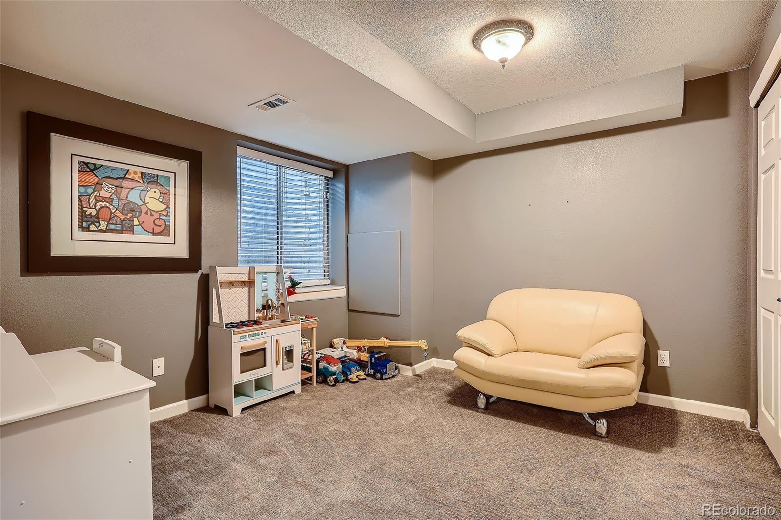8994 Bermuda Run Circle Highlands Ranch, CO 80130 - Photo 23 of 30 a bedroom with furniture and a window