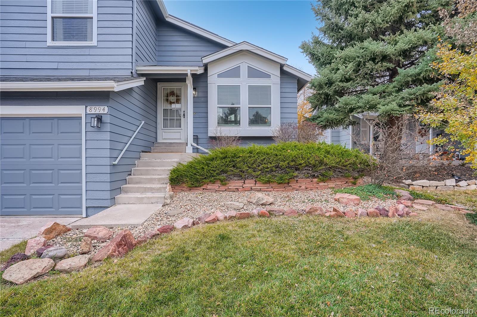 8994 Bermuda Run Circle Highlands Ranch, CO 80130 - Photo 3 of 30 a front view of a house with garden