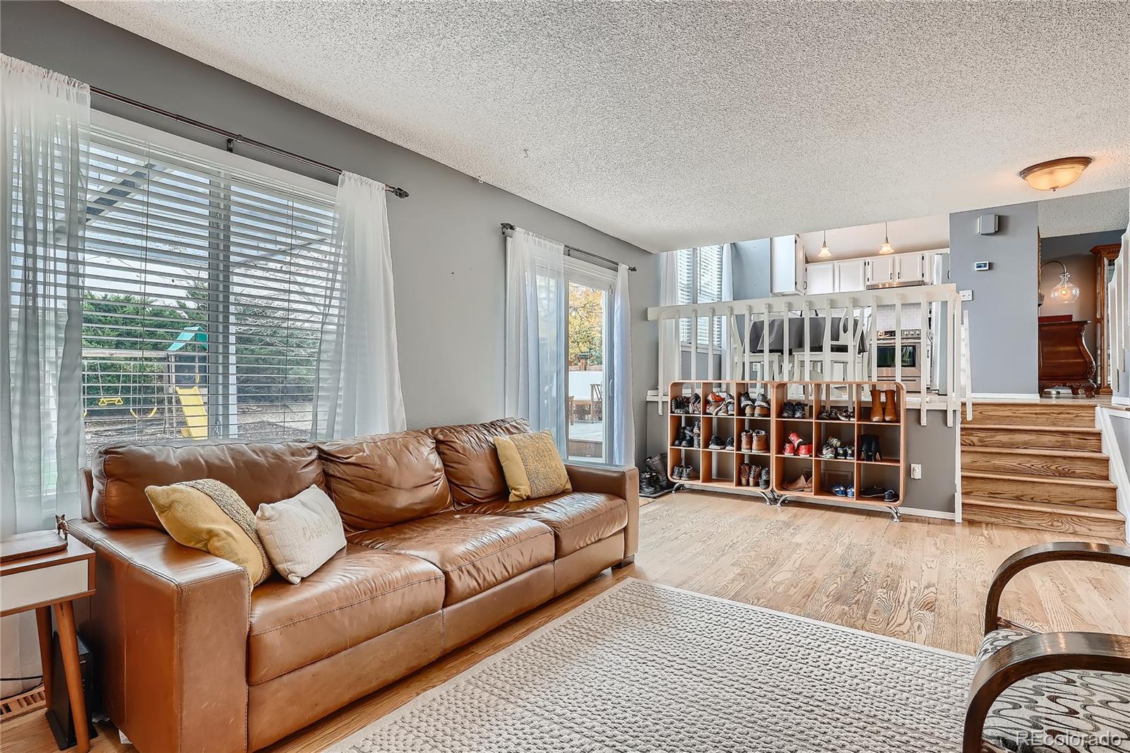 8994 Bermuda Run Circle Highlands Ranch, CO 80130 - Photo 6 of 30 a living room with furniture and a large window