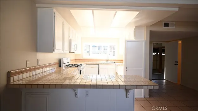 a kitchen with a sink a counter top space and cabinets