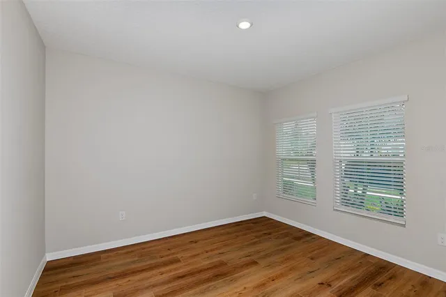 a bathroom with a toilet sink vanity and mirror