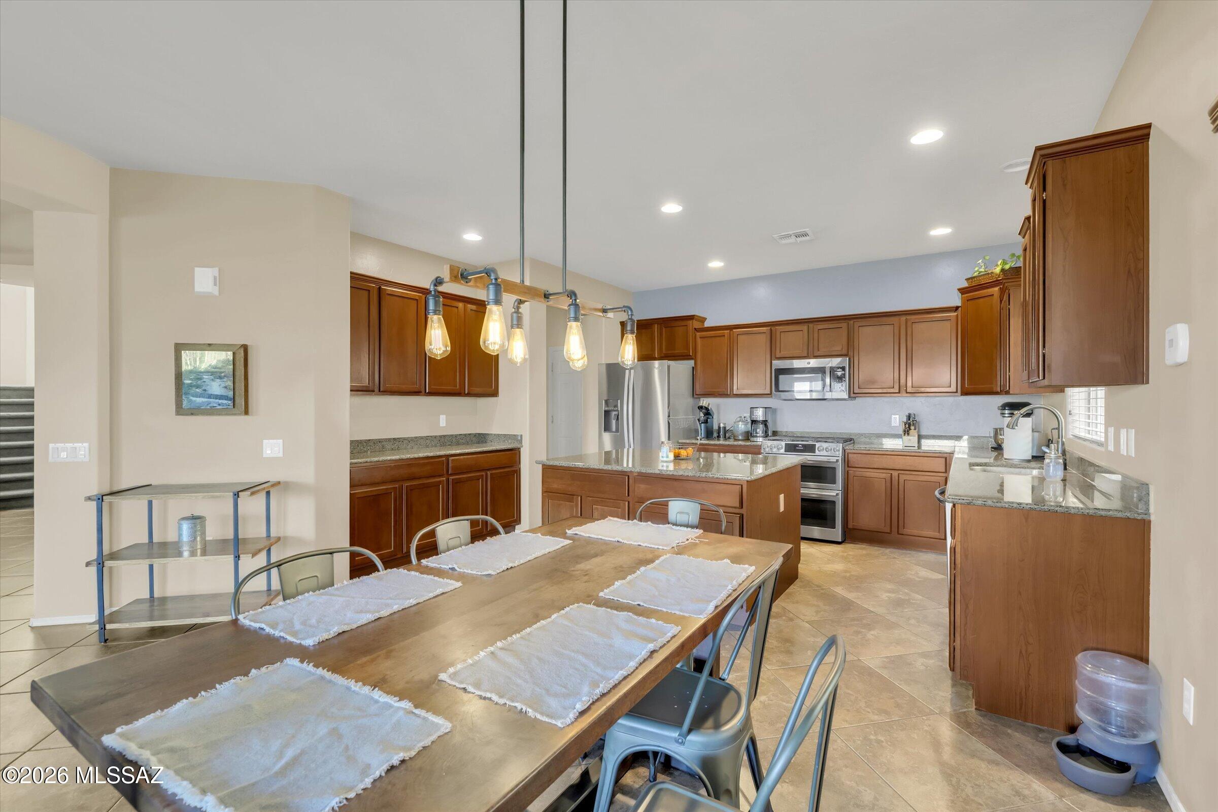 6095 South Jakemp Trail Tucson, AZ 85747 - Photo 4 of 52 a large kitchen with cabinets table and chairs