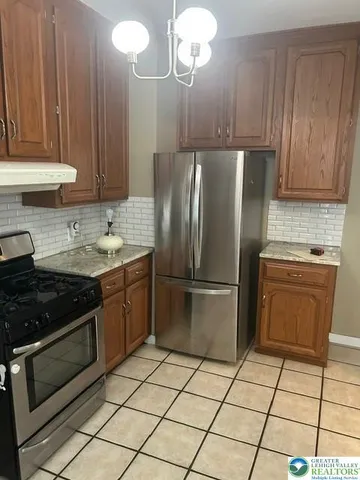a room that has a table chair and a stove in it