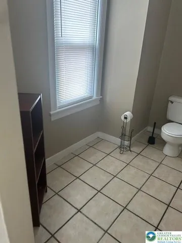 an entryway with wooden floor and cabinet