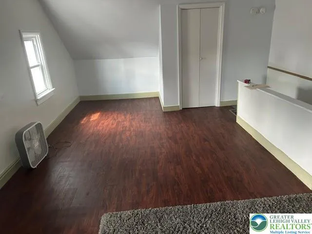 an empty room with wooden floor