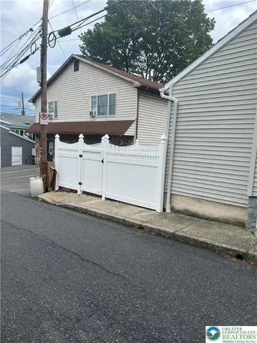 a view of a house with a yard and garage
