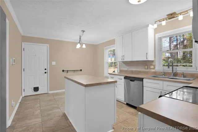 a kitchen with a sink window and cabinets
