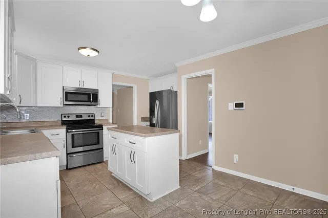 a kitchen with stove cabinets and refrigerator