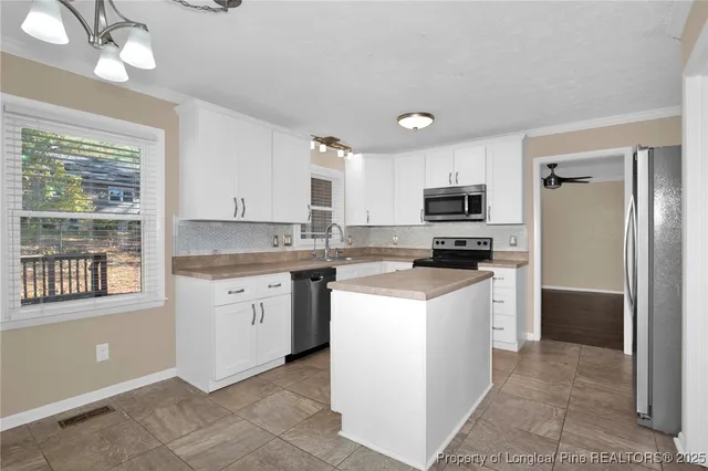 a kitchen with a refrigerator stove and sink