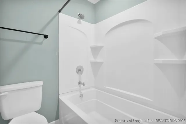 a bathroom with a toilet and a bathtub