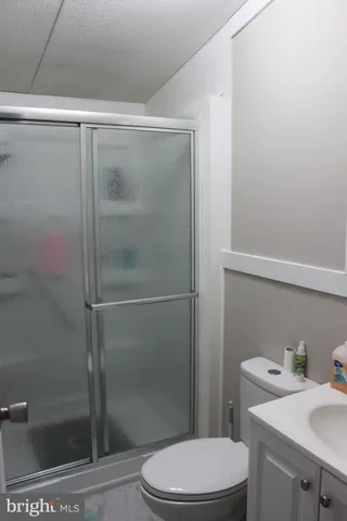 a bathroom with a shower a toilet and a sink