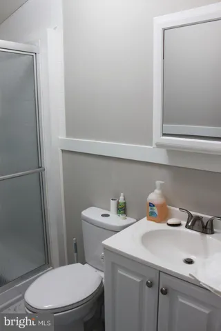 a bathroom with a sink a toilet and vanity